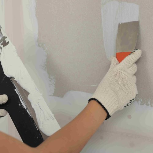 worker-smoothing-plaster-wall-with-spatula-indoors-2026-03-27-01-39-17-utc_11zon